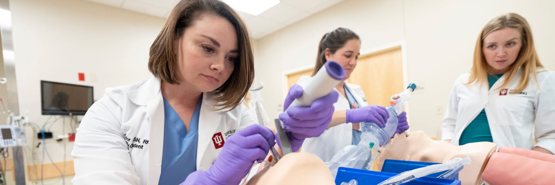 IU School of Nursing students practice airway management on a medical mannequin in a simulation lab.