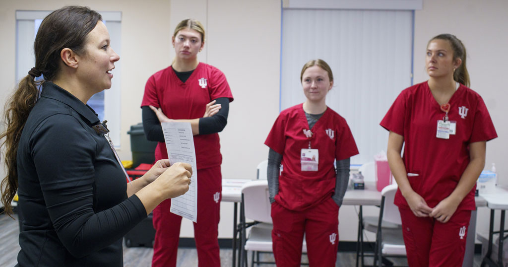 Dr. Britney Arce speaks with three IU School of Nursing students during a regional clinic experience.