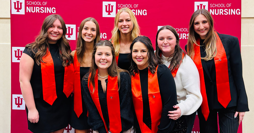 Several December 2025 graduates smile for a photo following the IU School of Nursing in Indianapolis pinning ceremony.
