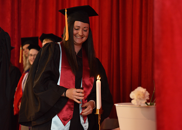 Graduate lighting candle